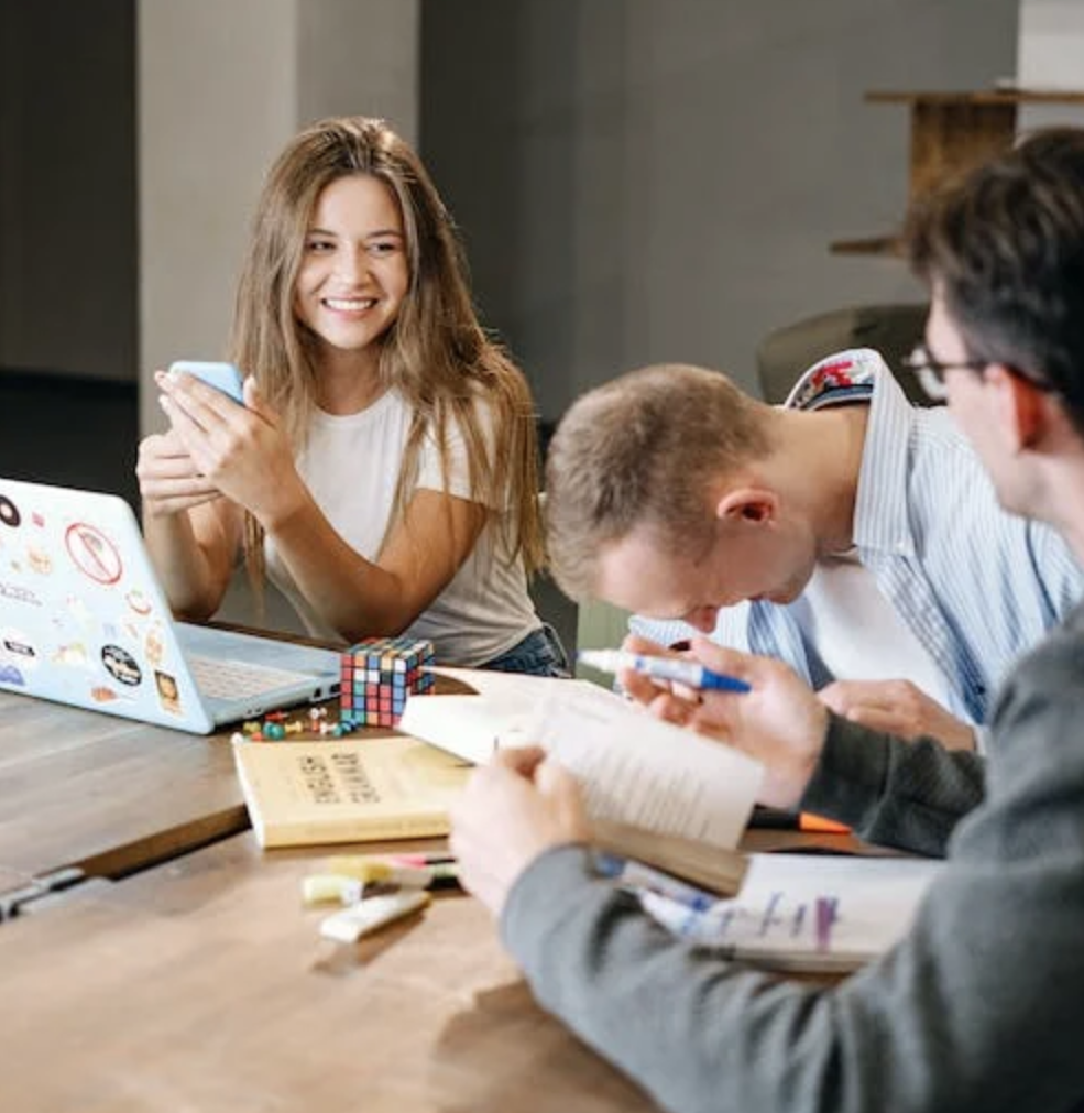 Smiling colleagues sitting together around a table.