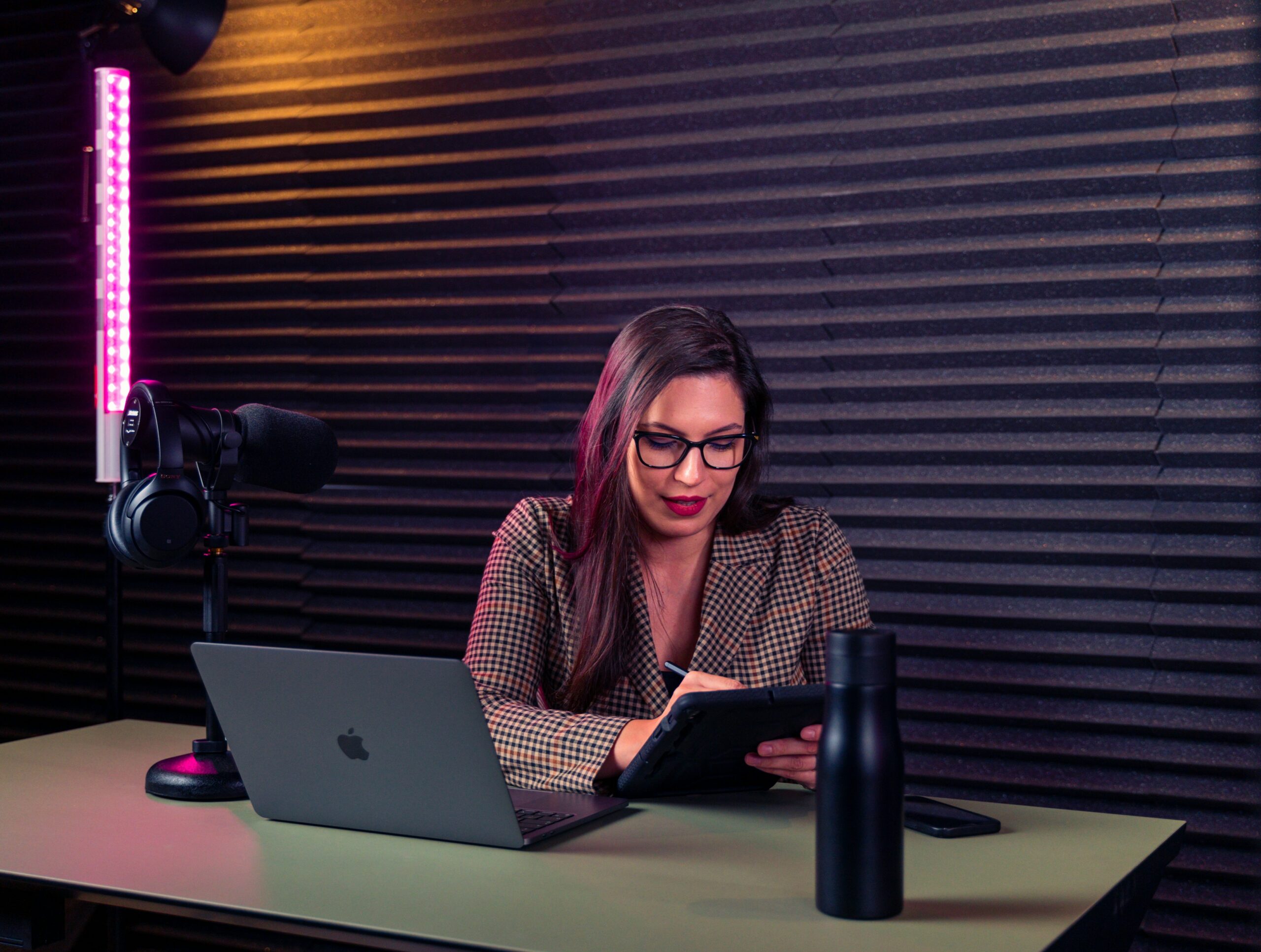 A woman sitting at a desk with a laptop