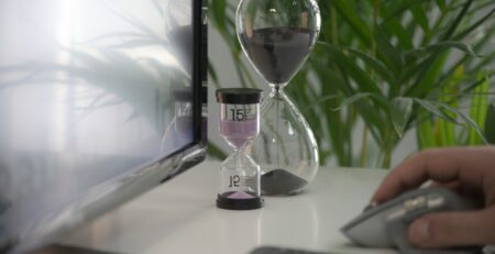 Hourglass in a white business desk.