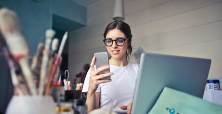 a woman wearing a white shirt using a phone