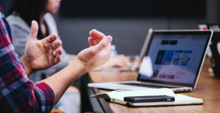 a man hands in front of a macbook