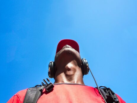 man looking to sky while uses a black headphone