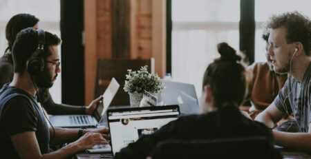 selective focus of people sits in front of table inside room