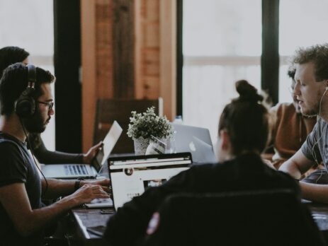 selective focus of people sits in front of table inside room