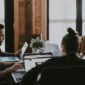 selective focus of people sits in front of table inside room