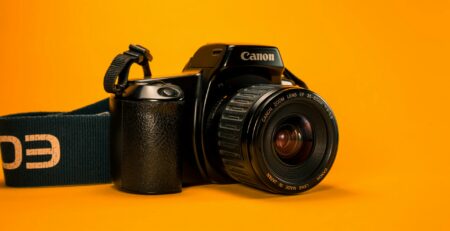 a photo camera in a orange background