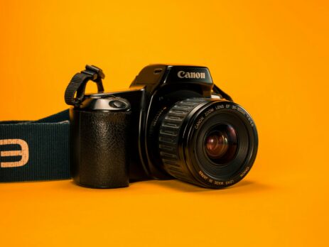 a photo camera in a orange background