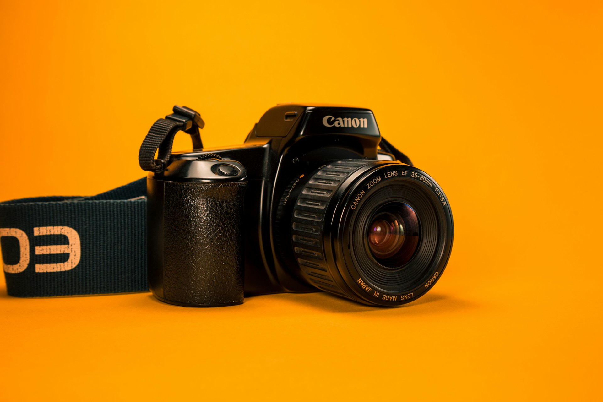 a photo camera in a orange background